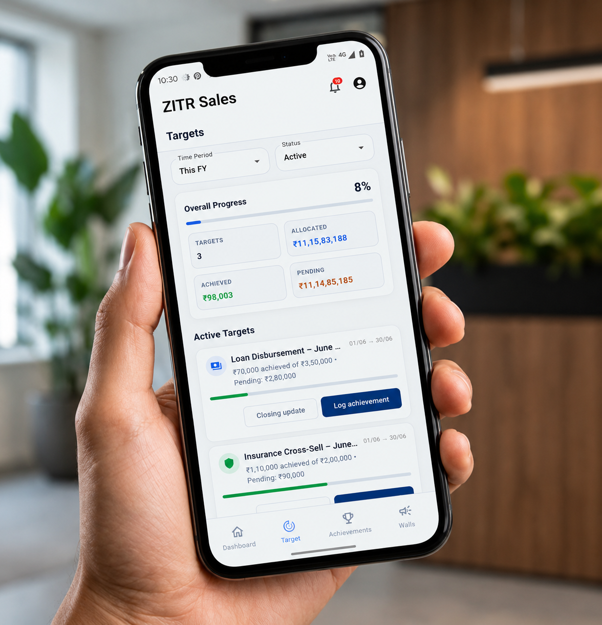 Hand holding phone with HR dashboard